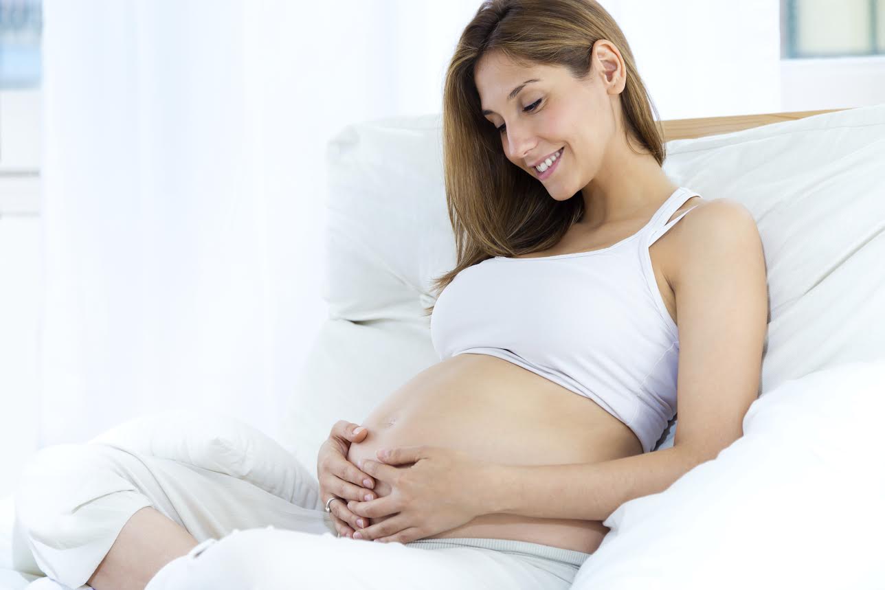 Portrait of pregnant woman relaxing at home.